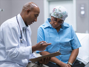 Photo of doctor speaking with cancer patient