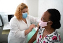 Doctor administering vaccine to patient