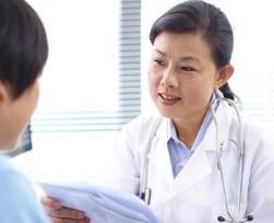 Female doctor talking to an older female patient with cancer