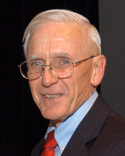 Headshot of Dr. Gordon Cragg wearing a suite with red tie