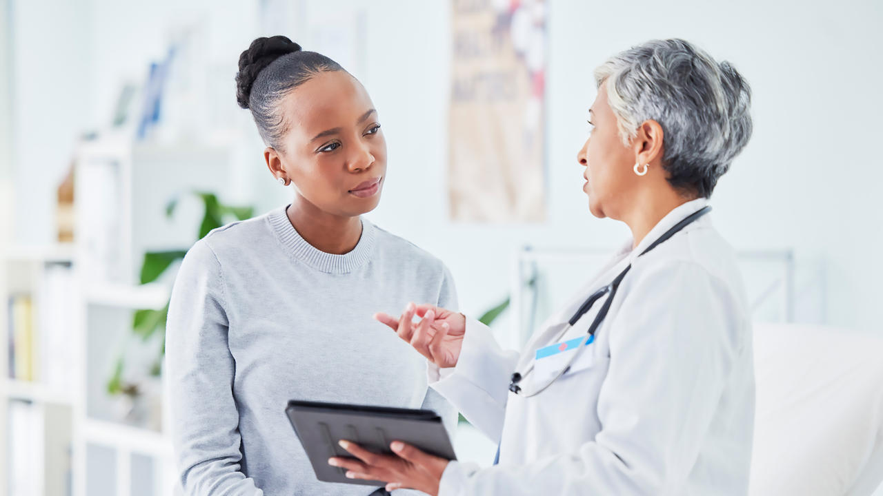 A female patient speaking with a female doctor